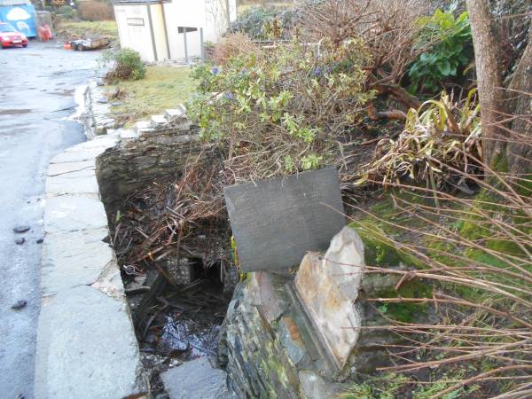 St Ciarán's plaque gets a wash in the holy well.