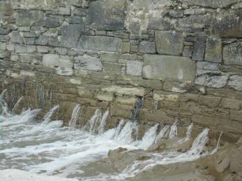 Water gushes through Duffys Pier